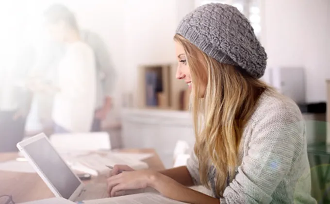 Woman working at a desk on her laptop