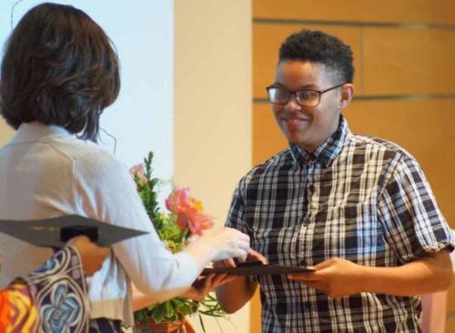 A student receiving an award at a ceremony. 