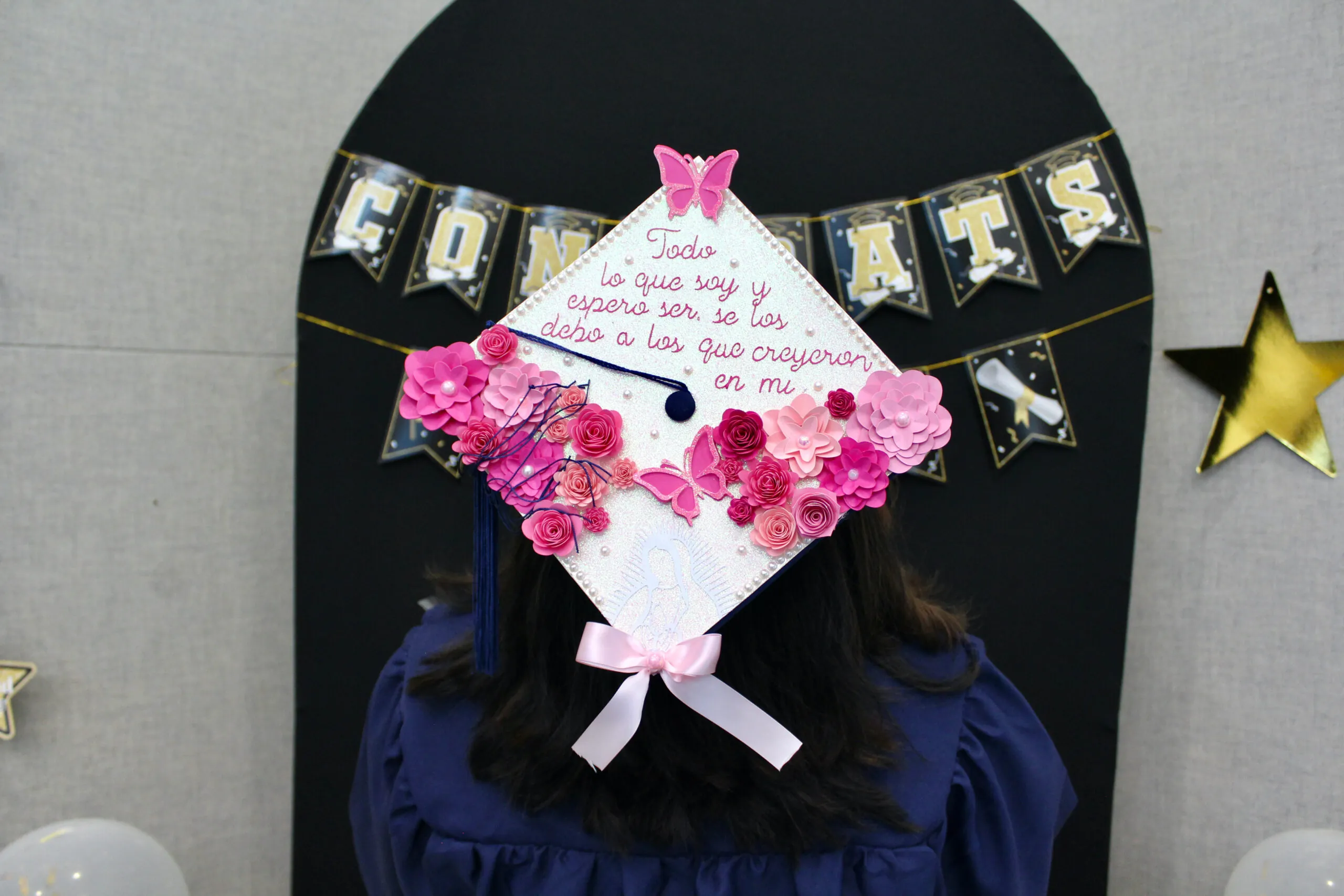 decorated graduation cap with pink flowers and butterflies. 