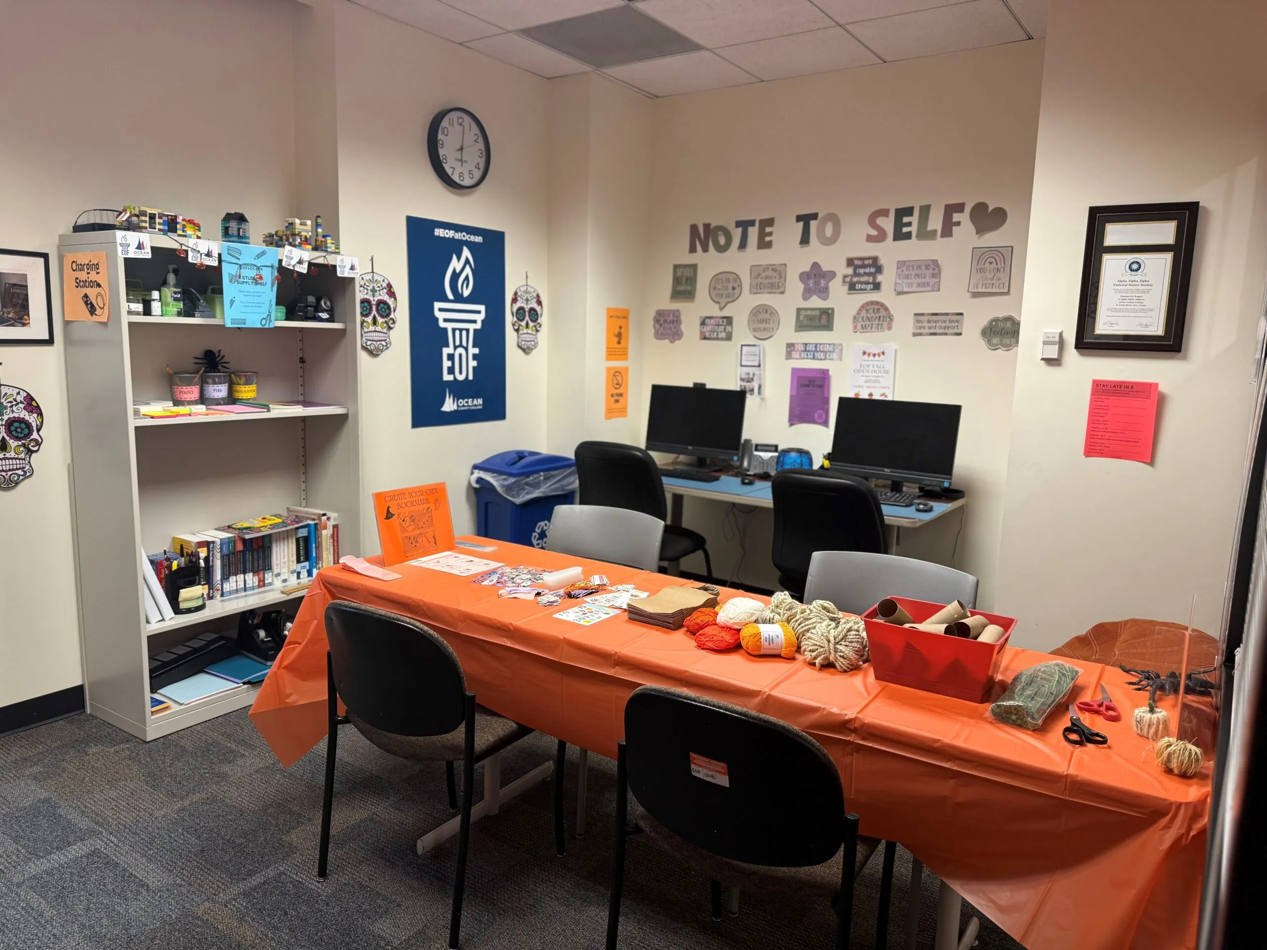 Student Room in the EOF office featuring computers, tables, and supply shelves. 