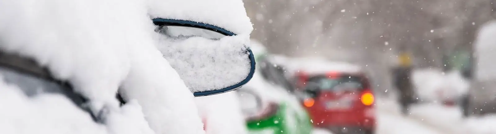 Close up of a car covered in snow
