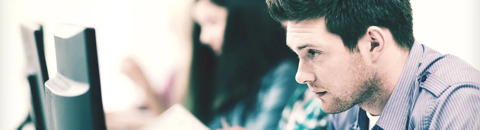 male student looking at computer