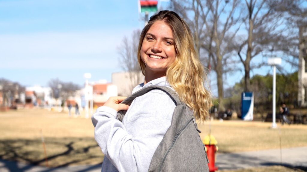Viking influencer standing posing for picture on campus