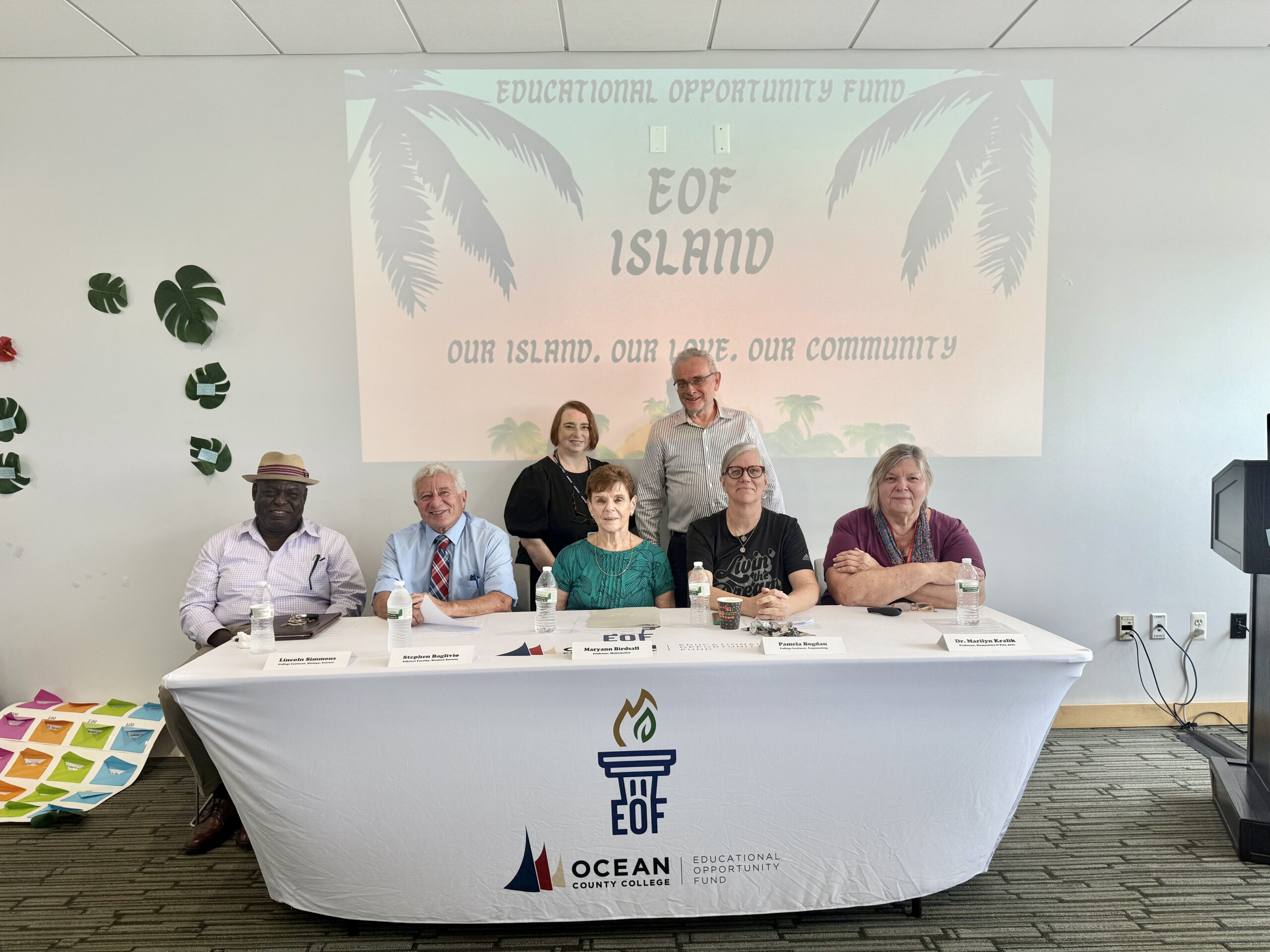 OCC faculty members sitting at a table during the faculty panel presentation 