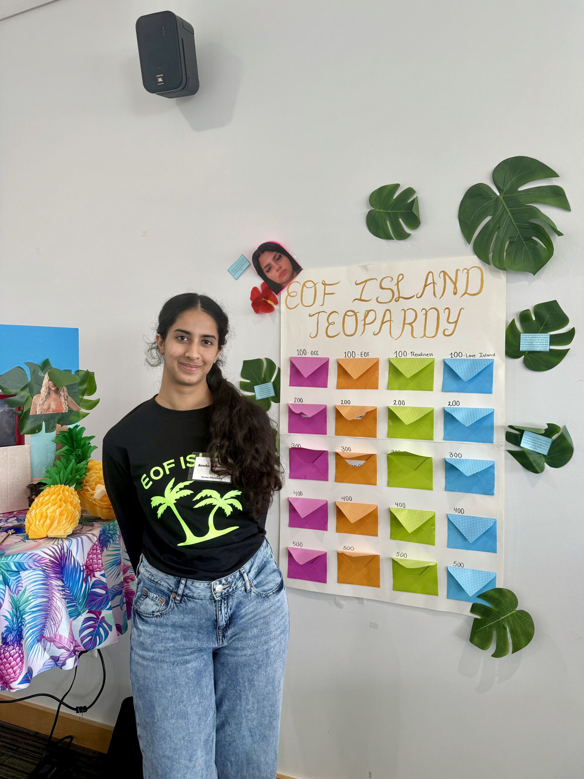 EOF student leader posing in front of a jeopardy poster