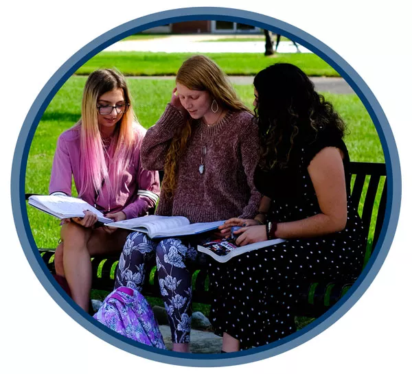 001757-CLRL-Tuition-Fee-Consolidation-TVv3-Images-1 three students sitting on a bench on campus studying