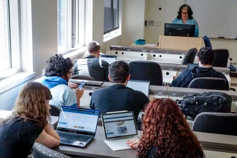 Students working on laptops in a classroom